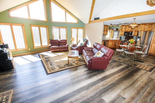 living room featuring high vaulted ceiling, a wealth of natural light, and dark hardwood / wood-style flooring