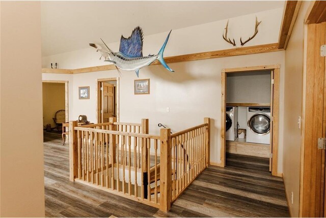 hall featuring lofted ceiling, independent washer and dryer, and dark wood-type flooring