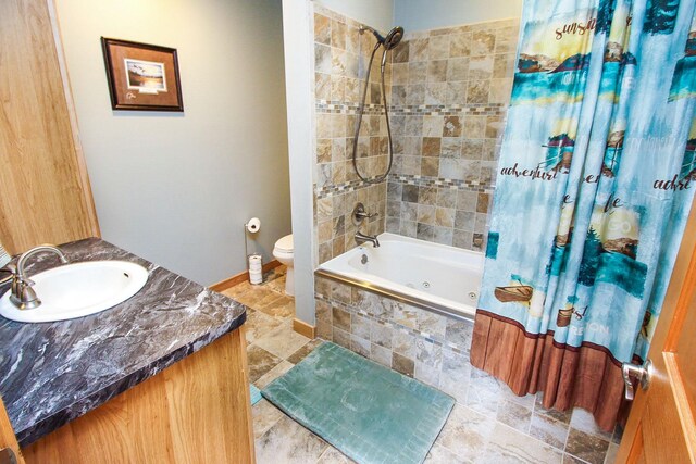 full bathroom featuring vanity, shower / bath combo with shower curtain, and toilet