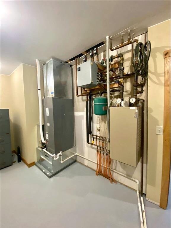 utility room featuring heating unit