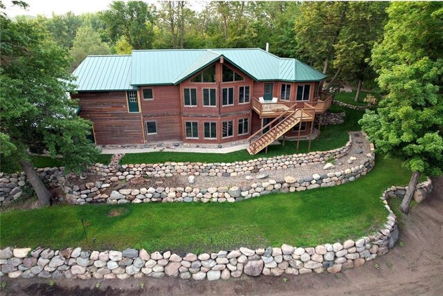 back of property with a yard and a wooden deck