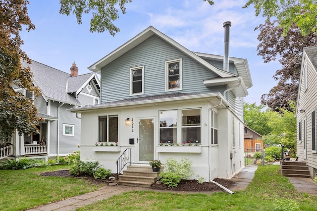 4512 47th Ave S, Minneapolis, MN 55406 - view of front of house with entry steps, a front yard, and a shingled roof