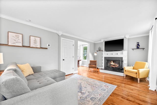 4512 47th Ave S, Minneapolis, MN 55406 - living room featuring ornamental molding, light wood finished floors, a tiled fireplace, and baseboards