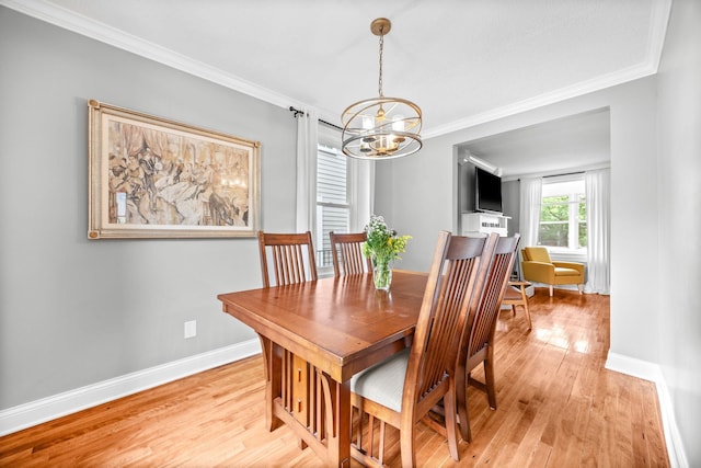 4512 47th Ave S, Minneapolis, MN 55406 - dining area with a chandelier, crown molding, light wood-style flooring, and baseboards