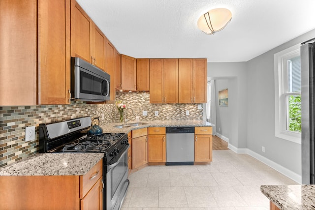 4512 47th Ave S, Minneapolis, MN 55406 - kitchen featuring appliances with stainless steel finishes, a sink, tasteful backsplash, and baseboards
