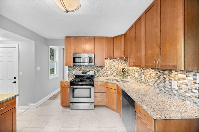 4512 47th Ave S, Minneapolis, MN 55406 - kitchen featuring appliances with stainless steel finishes, a sink, baseboards, decorative backsplash, and a textured ceiling