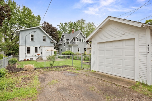 4512 47th Ave S, Minneapolis, MN 55406 - view of front of home featuring driveway, a detached garage, and an outdoor structure
