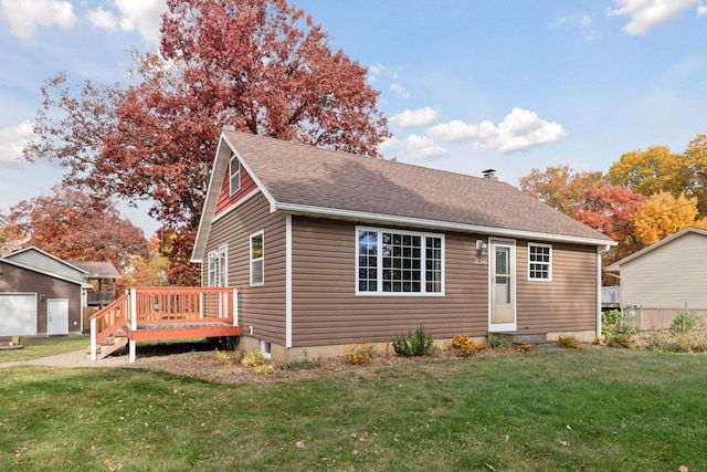 view of front of house with a wooden deck and a front lawn