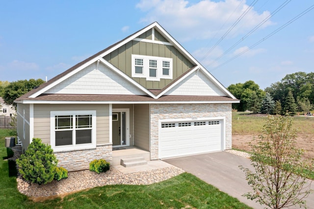 craftsman-style home featuring a garage and cooling unit