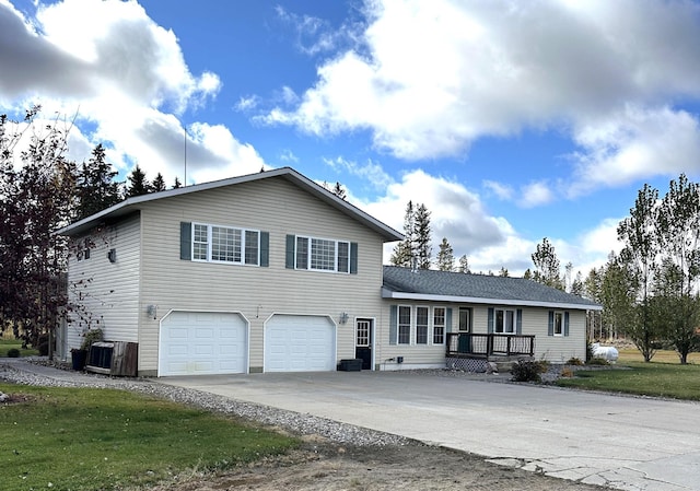 view of front facade with a garage, central AC, and a front lawn