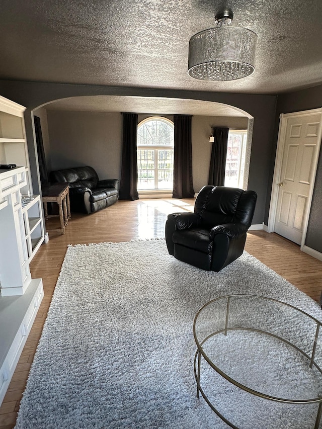 living room with wood-type flooring and a textured ceiling