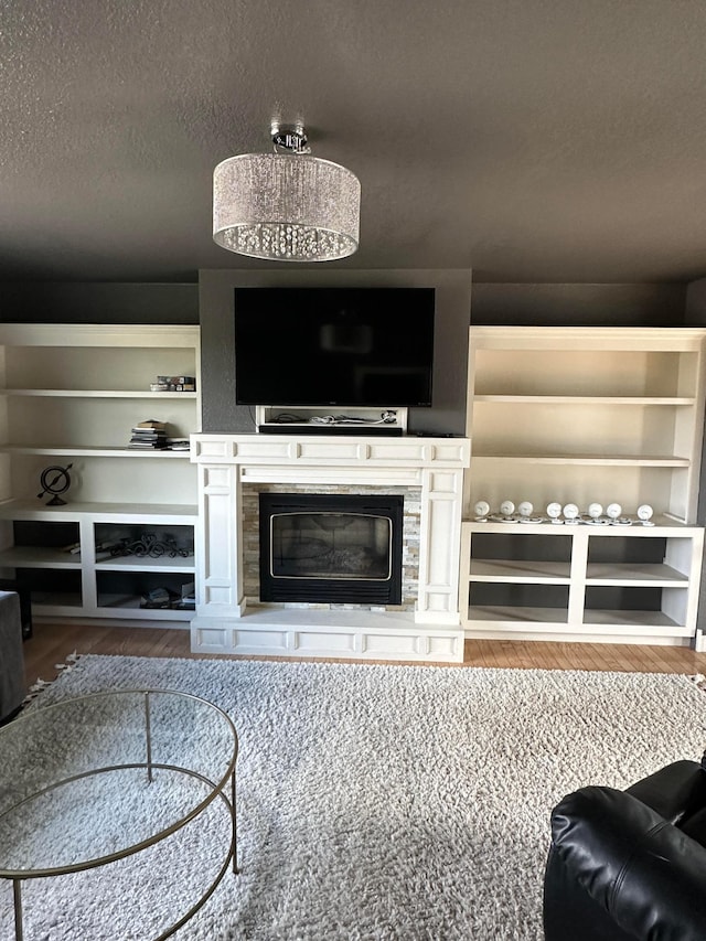 living room with a textured ceiling and hardwood / wood-style floors