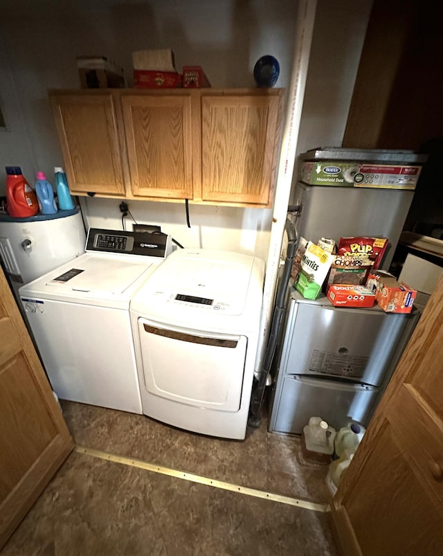 washroom featuring independent washer and dryer and cabinets