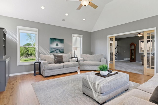 living room featuring ceiling fan, high vaulted ceiling, light wood-style floors, recessed lighting, and baseboards