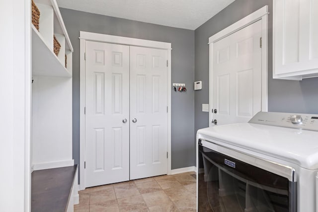 laundry area with cabinet space, baseboards, and separate washer and dryer