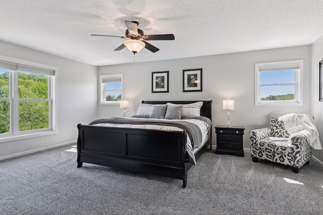 carpeted bedroom with baseboards, ceiling fan, and a textured ceiling