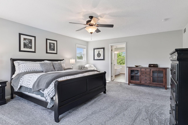 carpeted bedroom with baseboards, a ceiling fan, and ensuite bathroom