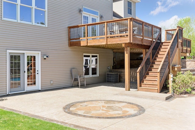 rear view of property featuring a patio area, a deck, central air condition unit, and stairs