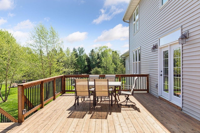 deck with outdoor dining area