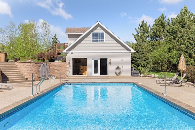 view of pool featuring stairs, an outdoor structure, a patio, and an exterior structure