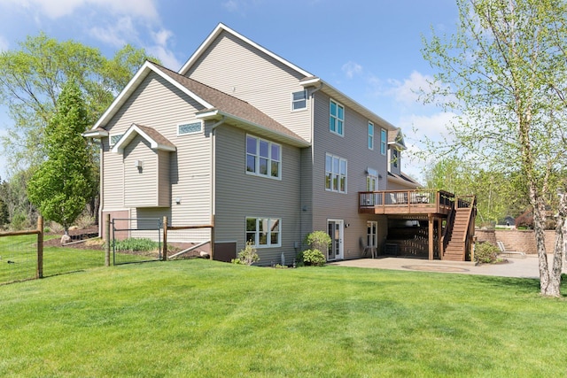 rear view of house featuring a wooden deck, a patio, and stairway
