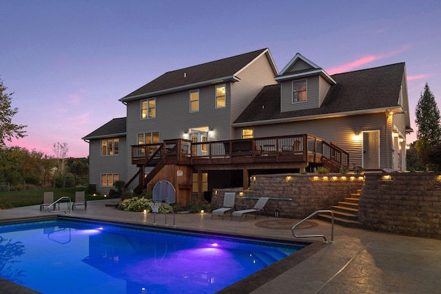 rear view of house with stairway, a patio area, a deck, and roof with shingles