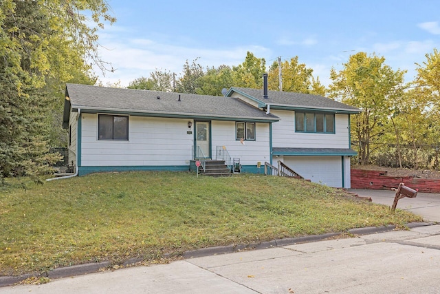 view of front of property with a garage and a front lawn