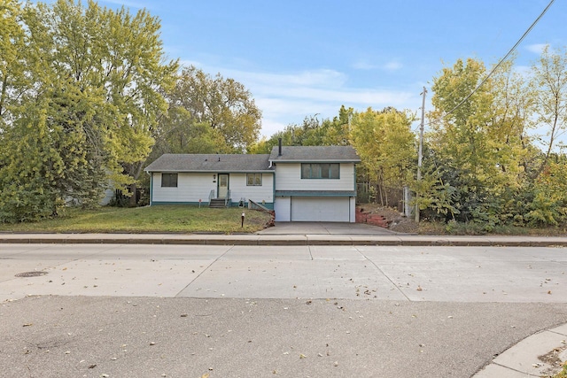 view of front of home with a garage and a front yard