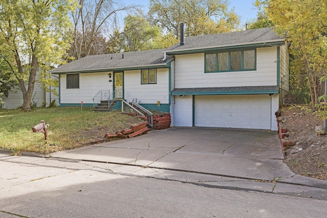 view of front of property featuring a garage and a front lawn