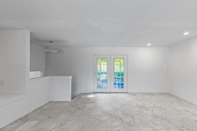 unfurnished room featuring french doors