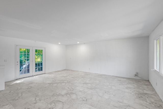 unfurnished room featuring french doors and a wealth of natural light