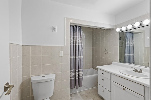 full bathroom with tile walls, shower / tub combo, vanity, and toilet