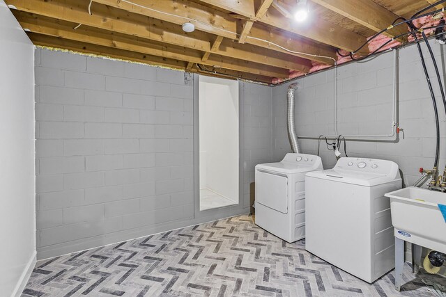 laundry room with separate washer and dryer and sink