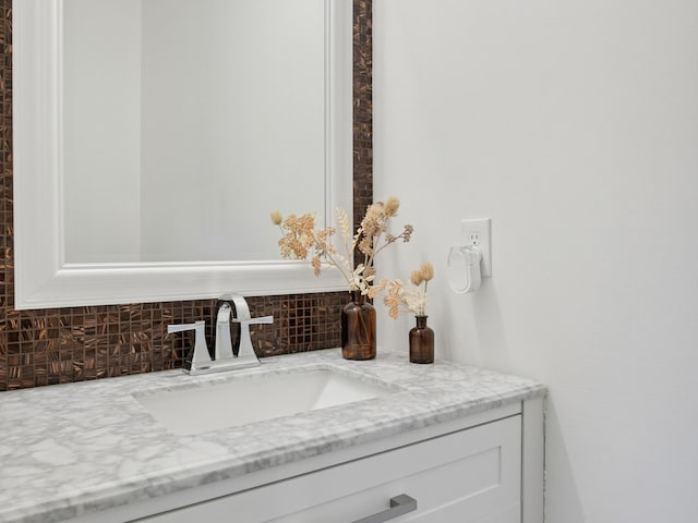 bathroom featuring vanity and decorative backsplash