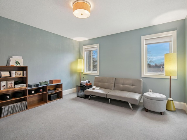 carpeted living room with a healthy amount of sunlight and baseboards