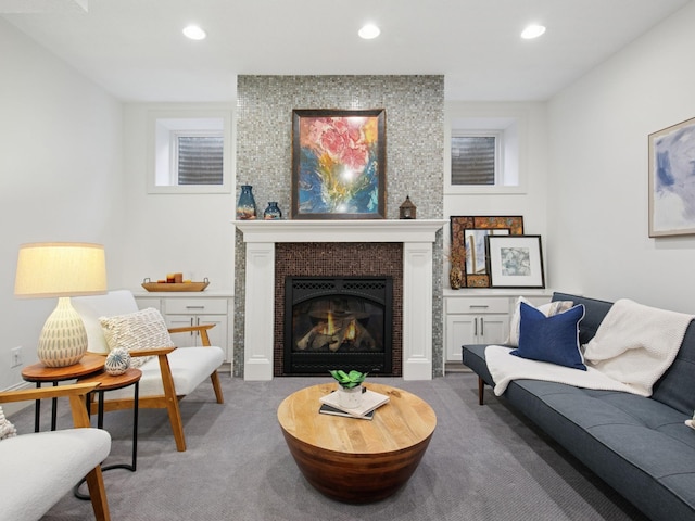 carpeted living room with recessed lighting and a fireplace