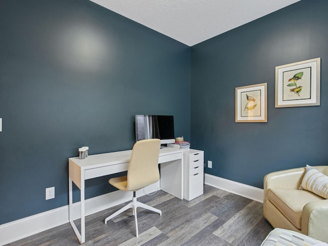 office area featuring dark wood-type flooring and baseboards