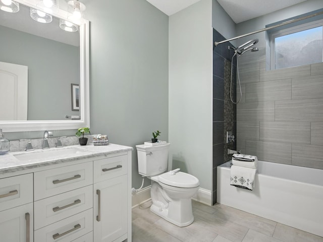 full bath with baseboards, vanity, toilet, and shower / bathtub combination