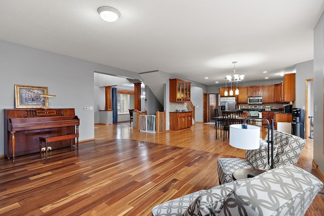 living room with a chandelier and light hardwood / wood-style floors