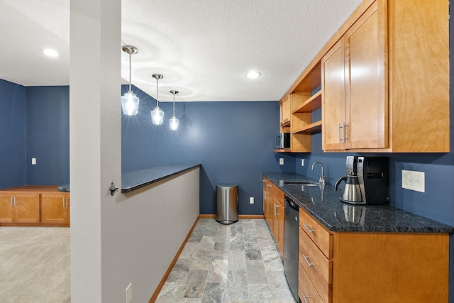 kitchen featuring light carpet, sink, dark stone countertops, dishwasher, and hanging light fixtures