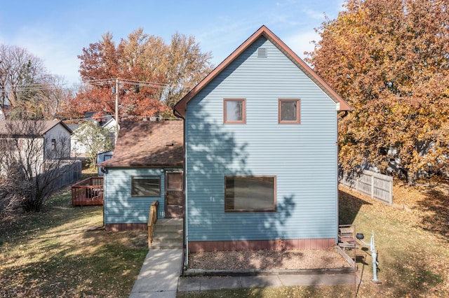 back of house with a lawn