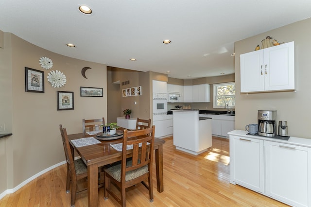 dining room featuring light hardwood / wood-style flooring and sink