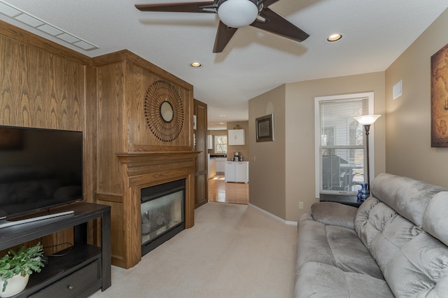 carpeted living room featuring ceiling fan