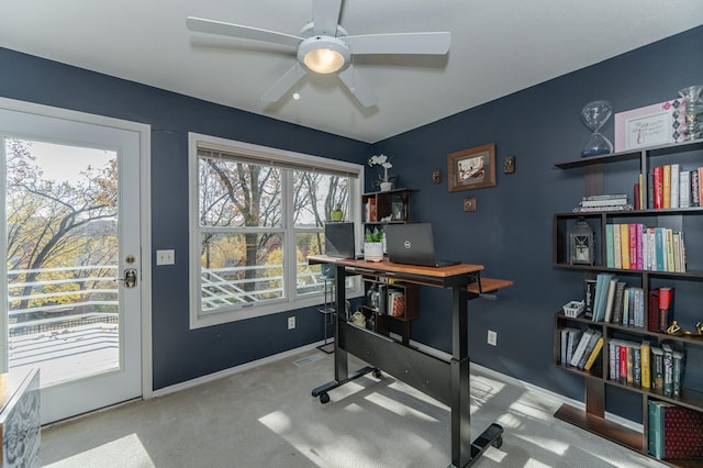 carpeted office space with ceiling fan