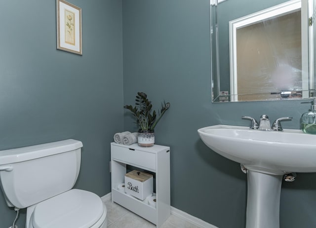 bathroom with toilet and tile patterned floors