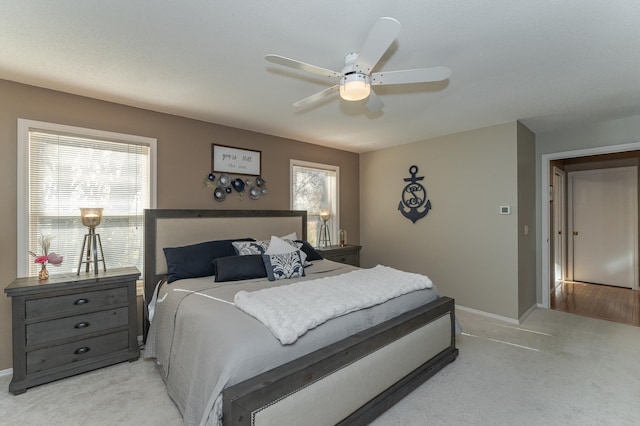 bedroom featuring light colored carpet and ceiling fan