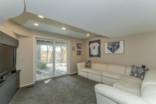 carpeted living room featuring a textured ceiling