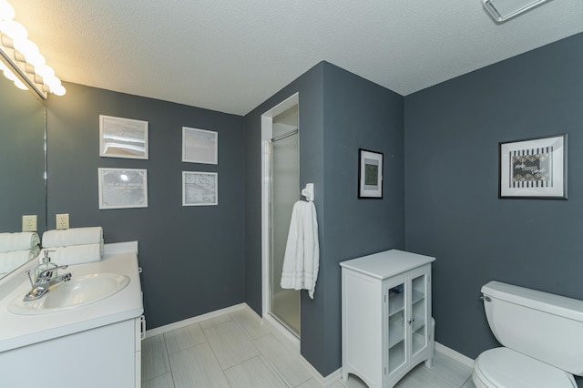 bathroom featuring vanity, a textured ceiling, toilet, and an enclosed shower