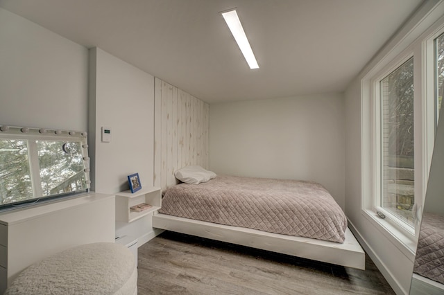 bedroom featuring light hardwood / wood-style floors and multiple windows