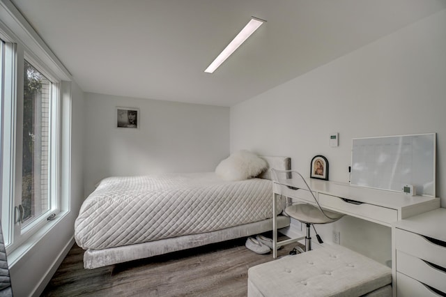 bedroom with dark hardwood / wood-style flooring